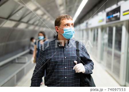 Man in medical mask on subway platform Man in medical mask on subway platform 74097553