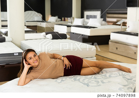 female buyer lying on mattress 74097898