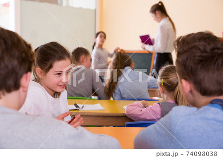 Pupils chattering at lesson Pupils chattering at lesson 74098038