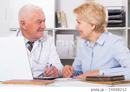 Male doctor with female client Male doctor with female client 74098212