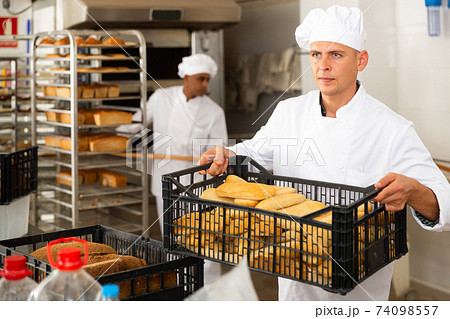 Portrait of baker with fresh bread at bakery 74098557