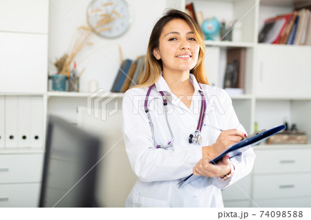 Doctor making notes on clipboard Doctor making notes on clipboard 74098588