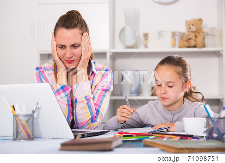 Irritated mother watching at the mistakes Irritated mother watching at the mistakes 74098754