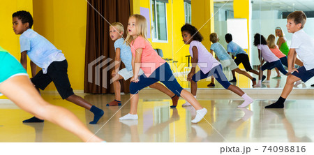 Emotional children performing modern dance in fitness studio 74098816