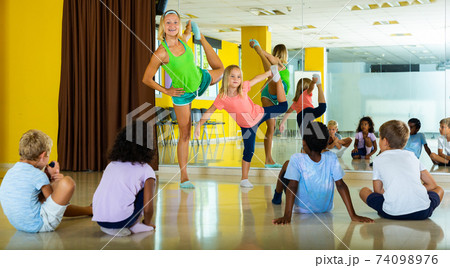 Smiling children dancing contemp in studio smiling and having fun Smiling children dancing contemp in studio smiling and having fun 74098976