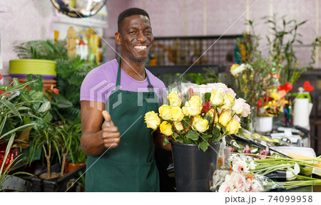 Florist giving thumbs up Florist giving thumbs up 74099958