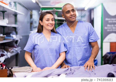 Portrait of two workers of dry-cleaning facility Portrait of two workers of dry-cleaning facility 74100683