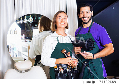 Woman makeup artist and man hairdresser in the salon Woman makeup artist and man hairdresser in the salon 74100689
