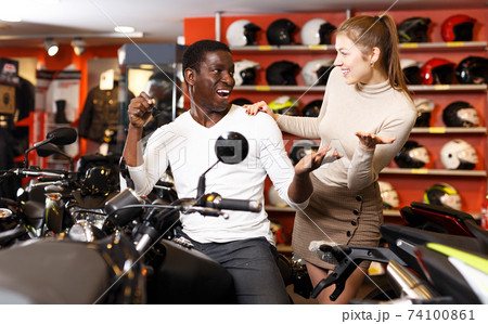 Couple posing on purchased motorcycle Couple posing on purchased motorcycle 74100861