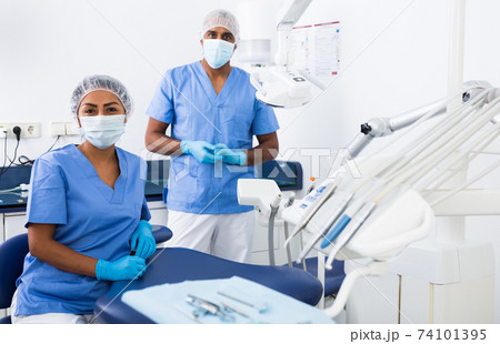 Doctors assistant prepares dentists workplace for work Doctors assistant prepares dentists workplace for work 74101395