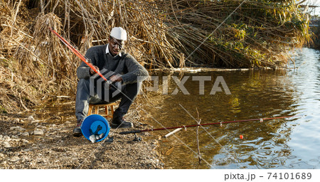 Man pulling fish with rods on river Man pulling fish with rods on river 74101689