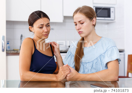 Upset young women friends having problems and quarrelling at home Upset young women friends having problems and quarrelling at home 74101873