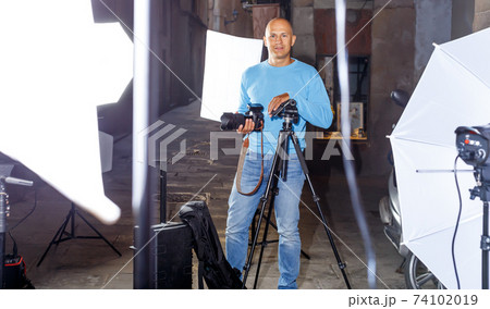 Professional photographer holding camera Professional photographer holding camera 74102019