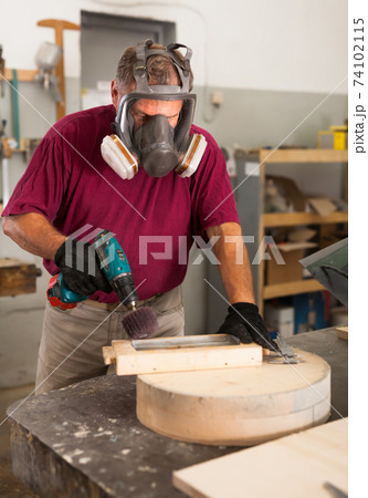 Worker in protective mask grinds wooden 3d detail Worker in protective mask grinds wooden 3d detail 74102115