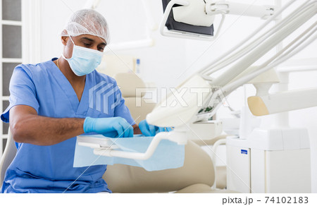 Dentist preparing special medical tools in dental office 74102183