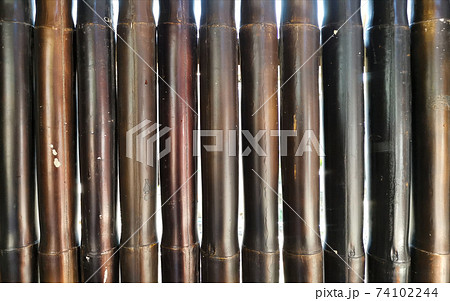 Black brown bamboo wall. Nature pattern background. Black brown bamboo wall. Nature pattern background. 74102244