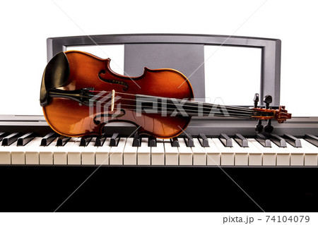 Violin on the desk electronic piano 74104079