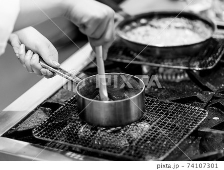 Chef cooking in a kitchen, chef at work, Black and White. 74107301