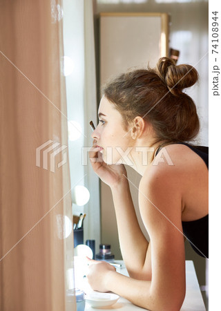 Woman applying brow tint 74108944