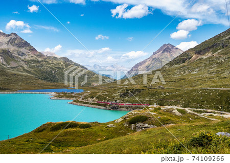 Bernina Express at the White Lake in Ospizio Bernina, Engadin, Switzerland 74109266