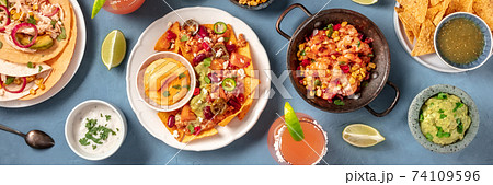 Mexican food, a flat lay overhead panorama on a blue background 74109596