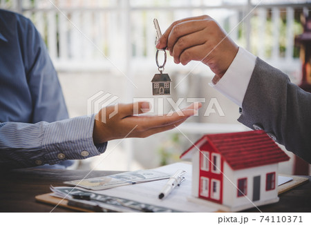 House signers signing signature loan document to home ownership with real estate agents ownership. Mortgage and real estate property investment, home insurance 74110371