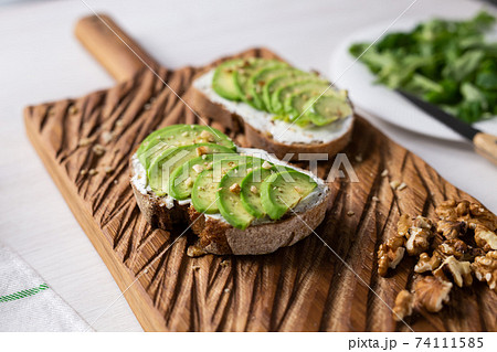 sliced avocado on toast bread with nuts sliced avocado on toast bread with nuts 74111585