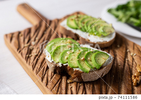 sliced avocado on toast bread with nuts sliced avocado on toast bread with nuts 74111586