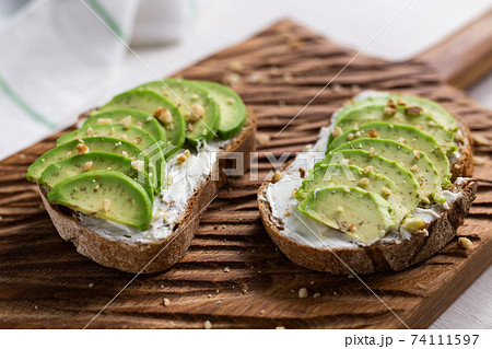 sliced avocado on toast bread with nuts sliced avocado on toast bread with nuts 74111597