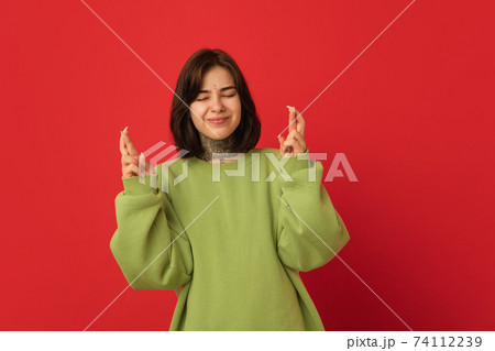 Caucasian woman's portrait isolated on red studio background with copyspace Caucasian woman's portrait isolated on red studio background with copyspace 74112239