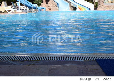 Swimming pool in touristic resort during summer time. Swimming pool in touristic resort during summer time. 74112827