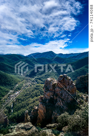 Spectacular mountain range with boulders and pine tree forest Spectacular mountain range with boulders and pine tree forest 74114088
