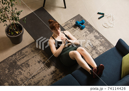 Young woman exercising fitness, aerobic, yoga at home, sporty lifestyle. Getting active during lockdown, quarantine. Home gym. Young woman exercising fitness, aerobic, yoga at home, sporty lifestyle. Getting active during lockdown, quarantine. Home gym. 74114426