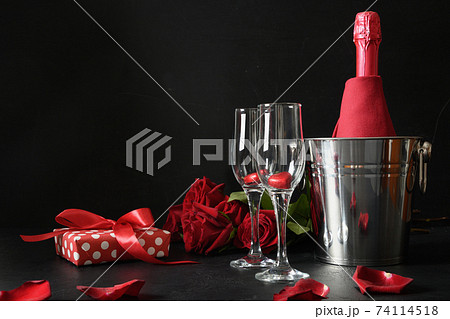 Red hearts chocolate sweets, wineglasses and red roses for Valentine's day. 74114518