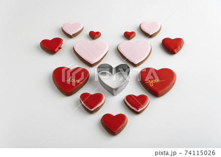 Many heart-shaped cookies with color sugar icing. White background. Valentines day treat. 74115026