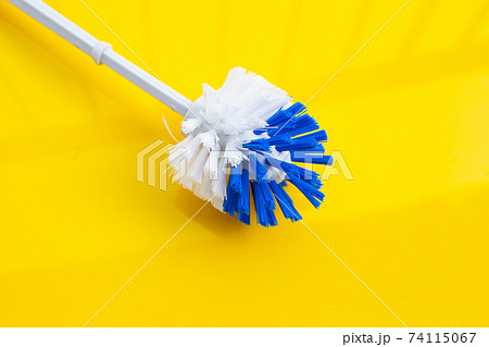 Toilet brush on yellow background. 74115067