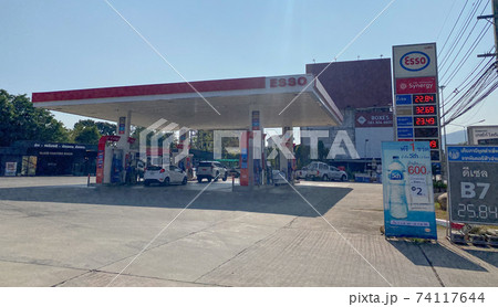 Chiangmai, Thailand-February 2, 2021 : ESSO major oil service station in Thailand, Fueling and gas locations for motorbikes and cars, Engine resting stations for long-distance vehicles, Oil station. 74117644