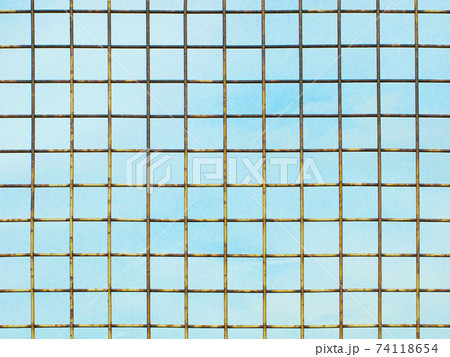 Metal lattice against light blue sky, illustration 74118654