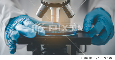 .Close up Researchers are testing samples under a microscope in a laboratory. .Close up Researchers are testing samples under a microscope in a laboratory. 74119730