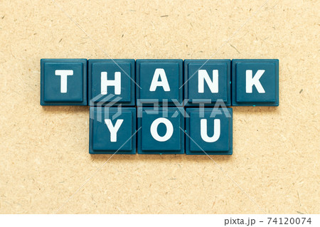 Tile alphabet letter in word thank you on wood background Tile alphabet letter in word thank you on wood background 74120074