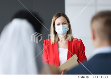 Woman protective medical mask on her face registering marriage 74121053