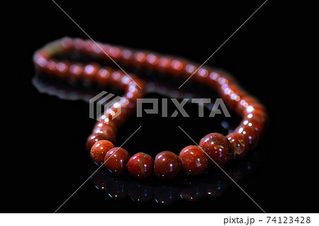 Brown jasper beads isolated on black background Brown jasper beads isolated on black background 74123428