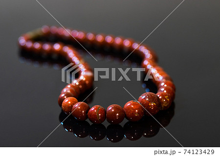 Brown jasper beads isolated on black background 74123429