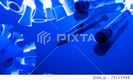 Virus protection. Medical syringe with needle for protection flu virus and coronavirus. Covid vaccine isolated on blue. Syringe, medical injection. Virus protection. Medical syringe with needle for protection flu virus and coronavirus. Covid vaccine isolated on blue. Syringe, medical injection. 74123488