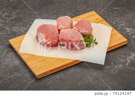 Raw pork medallion served rosemary Raw pork medallion served rosemary 74124197