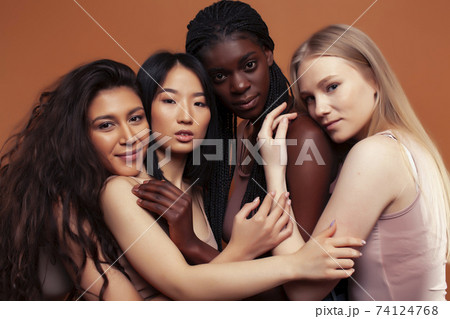 young pretty asian, caucasian, afro woman posing cheerful together on brown background, lifestyle diverse nationality people concept young pretty asian, caucasian, afro woman posing cheerful together on brown background, lifestyle diverse nationality people concept 74124768