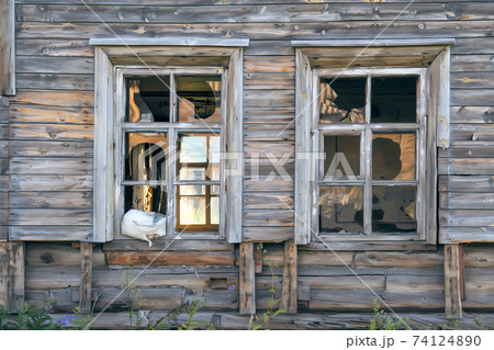 Old destroyed abandoned raw wooden house with the broken out windows 74124890