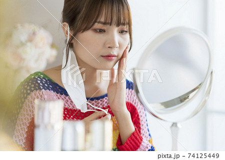 Young woman worrying about rough skin due to mask toothache 74125449