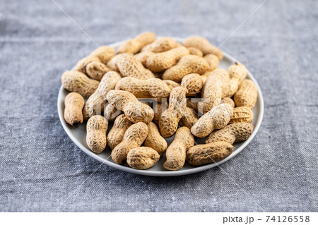 Roasted peanuts. Tasty groundnuts on plate. Roasted peanuts. Tasty groundnuts on plate. 74126558