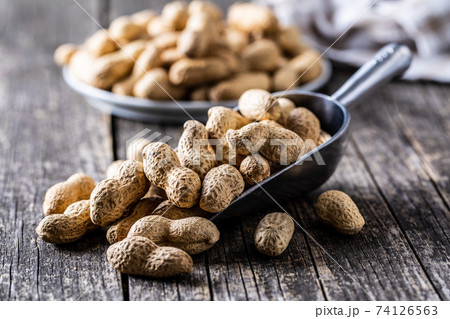 Roasted peanuts. Tasty groundnuts in metal scoop. Roasted peanuts. Tasty groundnuts in metal scoop. 74126563